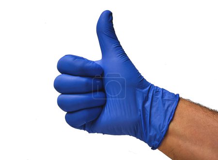 Photo for A doctor with a blue glove, makes a fist and raises his thumb, confirming that everything is correct, and that there is no problem, giving the ok. - Royalty Free Image