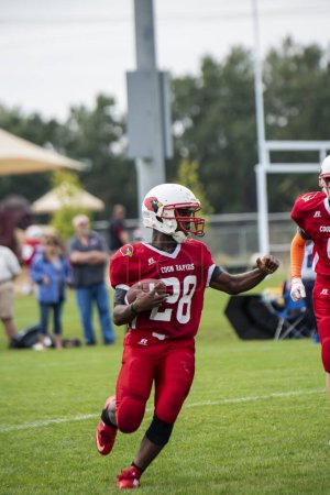 Foto de Coon Rapids, Minnesota. Middle school football game.  Running back with the football. - Imagen libre de derechos