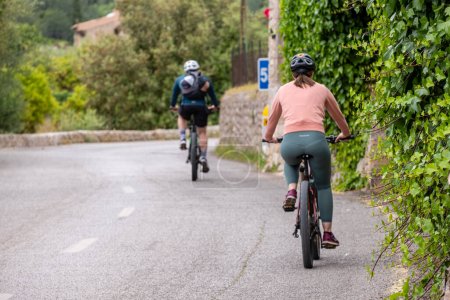 Photo for Two cyclists on the road, Fornalutx, Soller valley route, Mallorca, Balearic Islands, Spain - Royalty Free Image