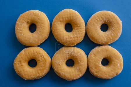 Photo for Six doughnuts on blue background - Royalty Free Image