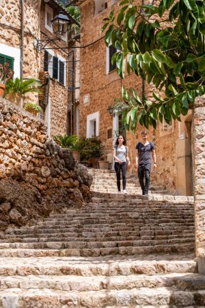 Photo for Couple in typical street, Fornalutx, Soller valley route, Mallorca, Balearic Islands, Spain - Royalty Free Image