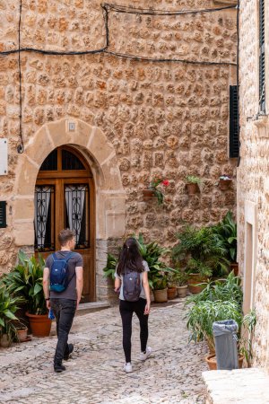 Photo for Couple in typical street, Fornalutx, Soller valley route, Mallorca, Balearic Islands, Spain - Royalty Free Image
