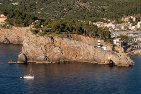 Photo for Ship entering Soller port, Punta de Sa Creu Ligthouse, Mallorca, Balearic Islands, Spain - Royalty Free Image
