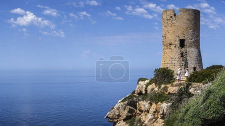 Photo for Tourists visiting Cap Blanc tower built in 1579, llucmajor, Mallorca, Balearic Islands, Spain - Royalty Free Image