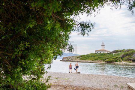 Photo for Beach and island of Alcanada, bathers in front of the lighthouse, Alcudia, - Royalty Free Image
