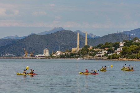 Photo for Group of canoeists sailing along the Alcanada coast, Alcudia, - Royalty Free Image