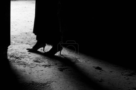 Foto de Black and white silhouette and shadow of woman wearing dress. Loneliness concept, dramatic human life - Imagen libre de derechos