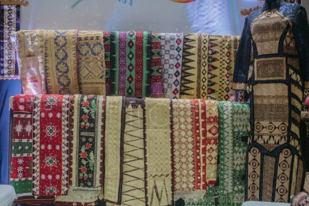 Photo for Fabric Various motifs. different fabrics displayed on the shelves. a fabric that can be called a typical tapis fabric from the province of Lampung in Indonesia. - Royalty Free Image