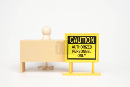 Photo for A picture of caution authorized personnel only sign with office desk miniature and peg dolls insight. - Royalty Free Image
