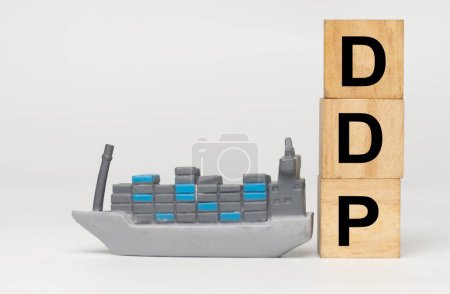 A picture of vessel with wooden block written DDP. Delivered Duty Paid Incoterm.