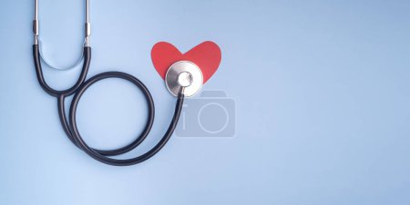 Photo for A stethoscope and red paper a heart shape isolated on a light blue background. Close-up photo. Top view. Flat lay with Space for text. Healthcare and medicine concept. - Royalty Free Image