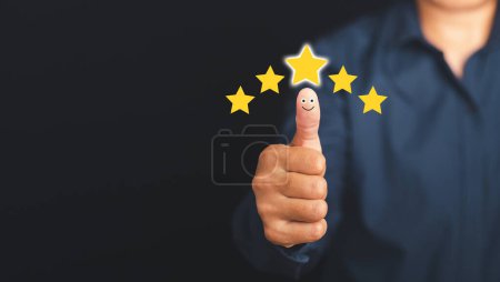 Photo for Best excellent services for satisfaction client giving a five-star rating. Customer feedback, service evaluation, experience, and satisfaction conceptual. Hand with thumb up for smiley face icon. - Royalty Free Image