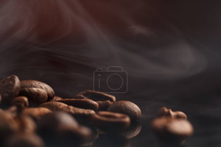 Téléchargez les photos : Grains de café sur un fond sombre avec un point culminant rouge sur le fond, grains de café gros plan pour un café. - en image libre de droit