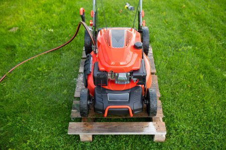 Photo for Self-propelled lawn mower with hose connection for cleaning the deck. - Royalty Free Image