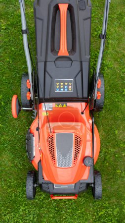 Photo for Powerful lawn mower on the grass, top view. - Royalty Free Image