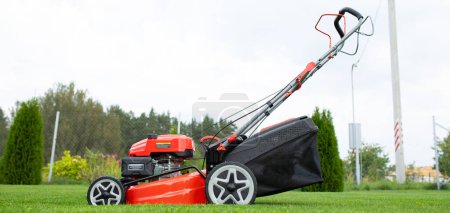 Photo for Petrol self-propelled lawn mower on green grass. - Royalty Free Image
