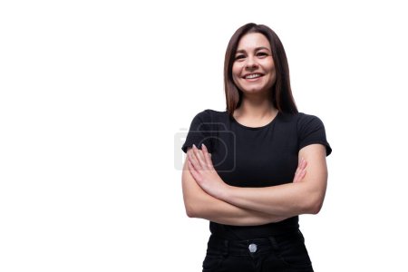 Photo for Young confident woman with black hair wearing a black T-shirt on a white background with copy space. - Royalty Free Image