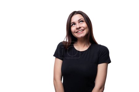 Photo for Young shy slim brunette woman inspired by an idea and smiling. - Royalty Free Image