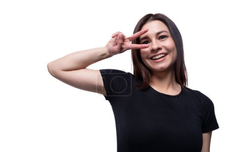 Photo for Young slender brunette woman with straight short hair wearing a black T-shirt. - Royalty Free Image