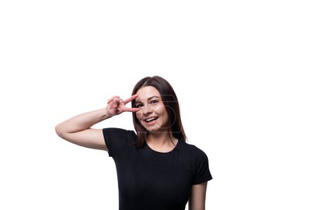 Photo for 25 year old cute woman with straight black hair dressed in a black T-shirt gesturing. - Royalty Free Image
