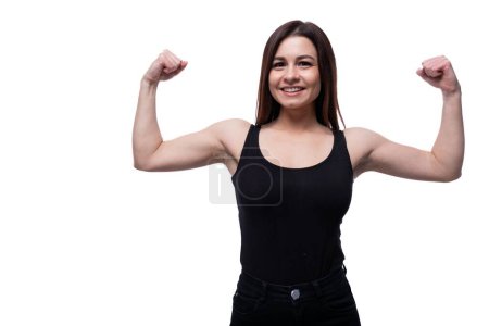 Photo for Caucasian young woman cutely showing strength and confidence. - Royalty Free Image