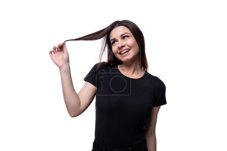 Photo for Young slender brunette woman with straight short hair wearing a black T-shirt. - Royalty Free Image
