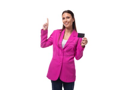 young boss woman dressed in a pink jacket shows a credit card with a mockup.
