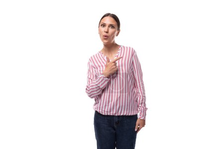 young brunette office worker woman dressed in a shirt points with her hands to the space for advertising.