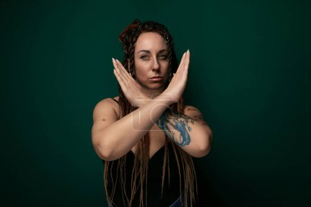 Photo for A woman with dreadlocks covering her face stands out as the main subject in the image. Her hair obscures most of her facial features, creating a mysterious and intriguing visual. - Royalty Free Image