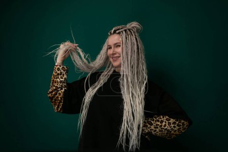 A woman with long white hair is wearing a leopard print sleeve, creating a bold and striking fashion statement. The contrast between her hair and the sleeve adds an edgy touch to her look, making her