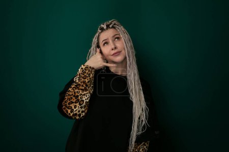 A woman with long white hair is wearing a stylish leopard print jacket. She exudes confidence and fashion sense as she walks down the street.