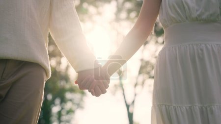Foto de Young adult two fiance asia lover man and woman happy begin couple date life flirt sweet care touch. Asian people bride groom fall in love relax hold hand swear with trust hope on newlywed family day. - Imagen libre de derechos