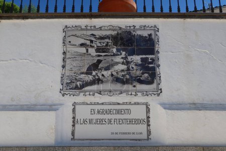 Photo for Fuenteheridos, Huelva, Spain, April 26, 2023: Poster in gratitude to the women in the fountain of the twelve pipes in the square of Fuenteheridos, Huelva, Spain - Royalty Free Image
