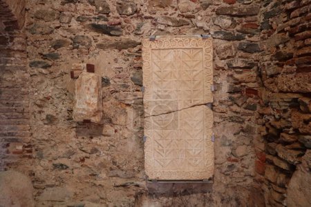 Photo for Almonaster la Real, Huelva, Spain, June 21, 2023: Ancient marbles on a wall of the 10th century mosque of Almonaster la Real. Huelva, Spain - Royalty Free Image