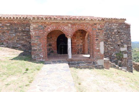 Photo for Almonaster la Real, Huelva, Spain, June 21, 2023: Arches of the west portico from the exterior of the 10th century mosque of Almonaster la Real. Huelva, Spain - Royalty Free Image
