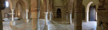 Photo for Almonaster la Real, Huelva, Spain, June 21, 2023: Panoramic of the 13th century Romanesque altar, mihrab in the prayer room and west exit door of the 10th century mosque of Almonaster la Real. Huelva, Spain - Royalty Free Image