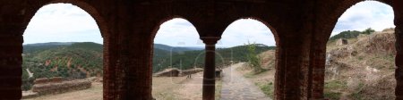 Photo for Almonaster la Real, Huelva, Spain, June 21, 2023: Panoramic of the Sierra de Aracena from the arches of the west portico of the X century mosque of Almonaster la Real. Huelva, Spain - Royalty Free Image