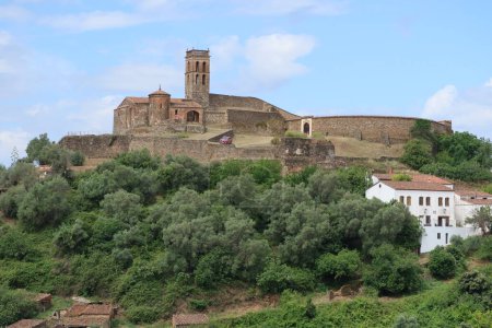 Photo for Almonaster la Real, Huelva, Spain, June 21, 2023: Mosque, bullring and houses of the village of Almonaster la Real in the Sierra de Aracena, Huelva, Spain - Royalty Free Image