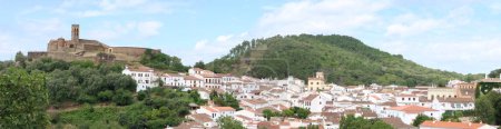 Photo for Almonaster la Real, Huelva, Spain, June 21, 2023: Panoramic of the mosque, bullring and village of Almonaster la Real in the Sierra de Aracena, Huelva, Spain - Royalty Free Image