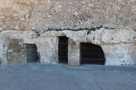 Villena, Alicante, Spain, March 6, 2024: Ancient cave houses at the base of the medieval castle of Arab origin of Atalaya. Villena, Alicante, Spain