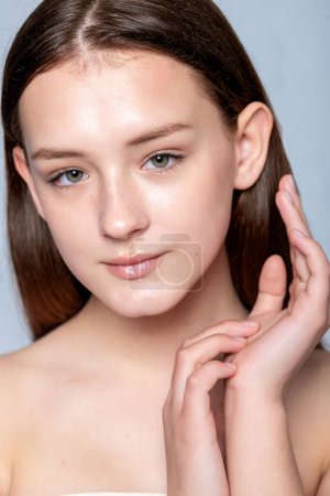 Photo for Discover the beauty of relaxation as a young woman indulges in facial treatment. Perfect for spa and wellness promotions. - Royalty Free Image
