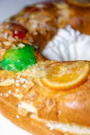 Photo for Roscn. Roscon de Reyes. Kingcake. Bun made with a sweet dough in the shape of a toroid decorated with slices of candied, candied or crystallized fruit of various colors with cream inside. - Royalty Free Image