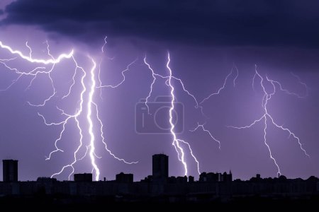 Photo for Ray. Lightning. Electric storm. Strong electrical storm with lots of lightning and thunder. Electrical storm over fields. Lightning photography. Silhouette of buildings and trees. - Royalty Free Image