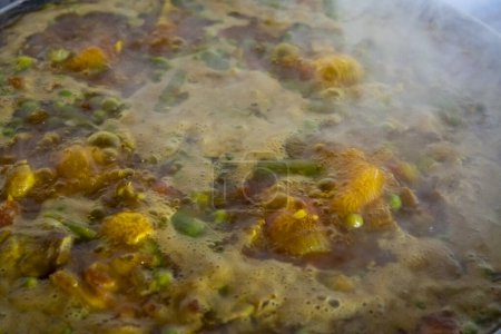 Photo for Close-up of boiling broth in the preparation of a dish of Spanish gastronomy, a Paella - Royalty Free Image