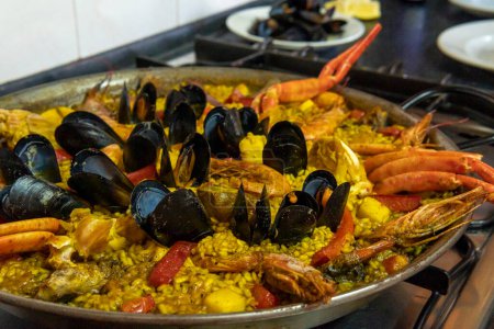Fermeture d'une paella de fruits de mer dans une poêle à paella. Image de la gastronomie méditerranéenne espagnole