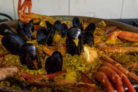 Close- up of a seafood paella in a paella pan. Image of the Spanish Mediterranean gastronomy