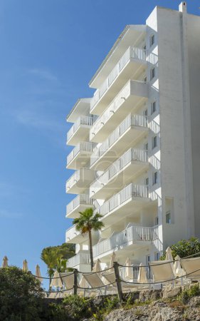 Exterior view of a white hotel complex in the Mallorcan resort of Cala d'Or on a sunny morning