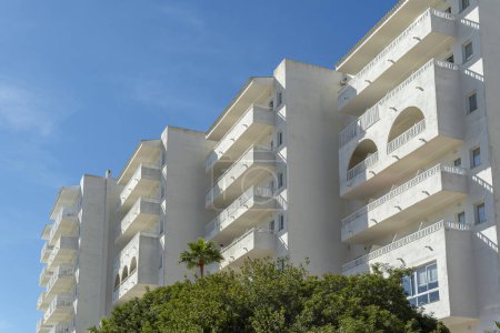 Exterior view of a white hotel complex in the Mallorcan resort of Cala d'Or on a sunny morning