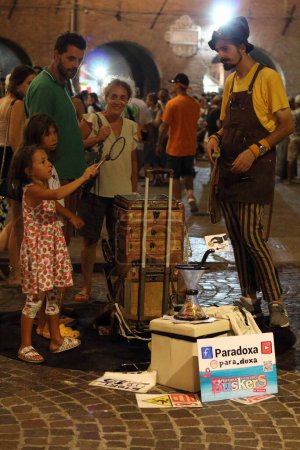 Photo for Ferrara, Italia - August 26, 2022: The Ferrara Buskers Festival is dedicated to the art of the street. The juggler Paradoxa entertains children and families with his games. - Royalty Free Image