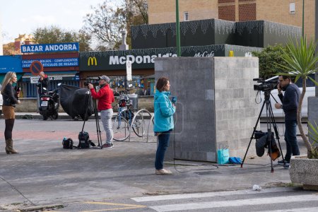 Photo for Seville, Spain; December 10th 2022: Journalists from the television broadcasting live from the street. Media covering a news story live. - Royalty Free Image